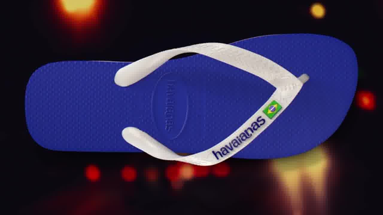 A Havaianas sandal rendered in CG by LOBO, turning against a city held out of focus