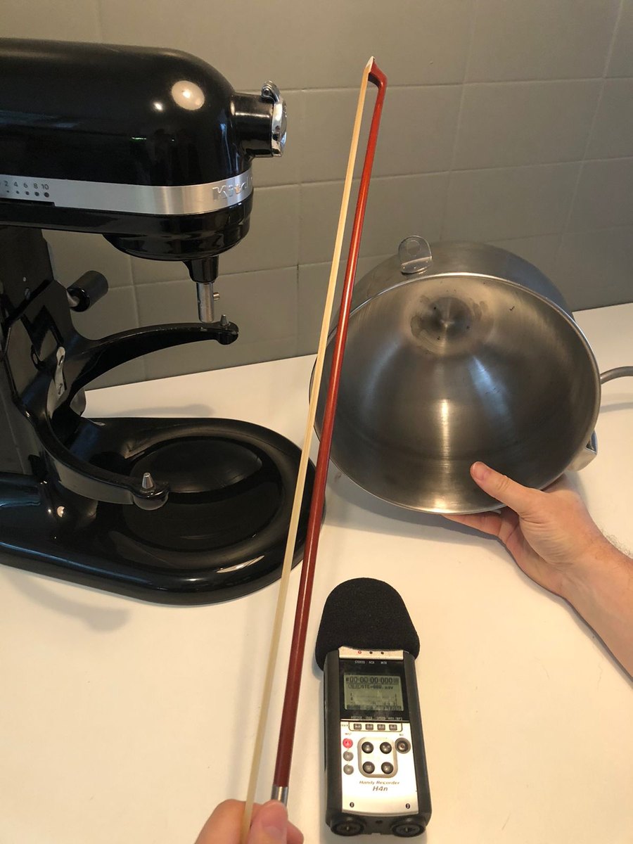 A violin bow drawn along the rim of the mixing bowl