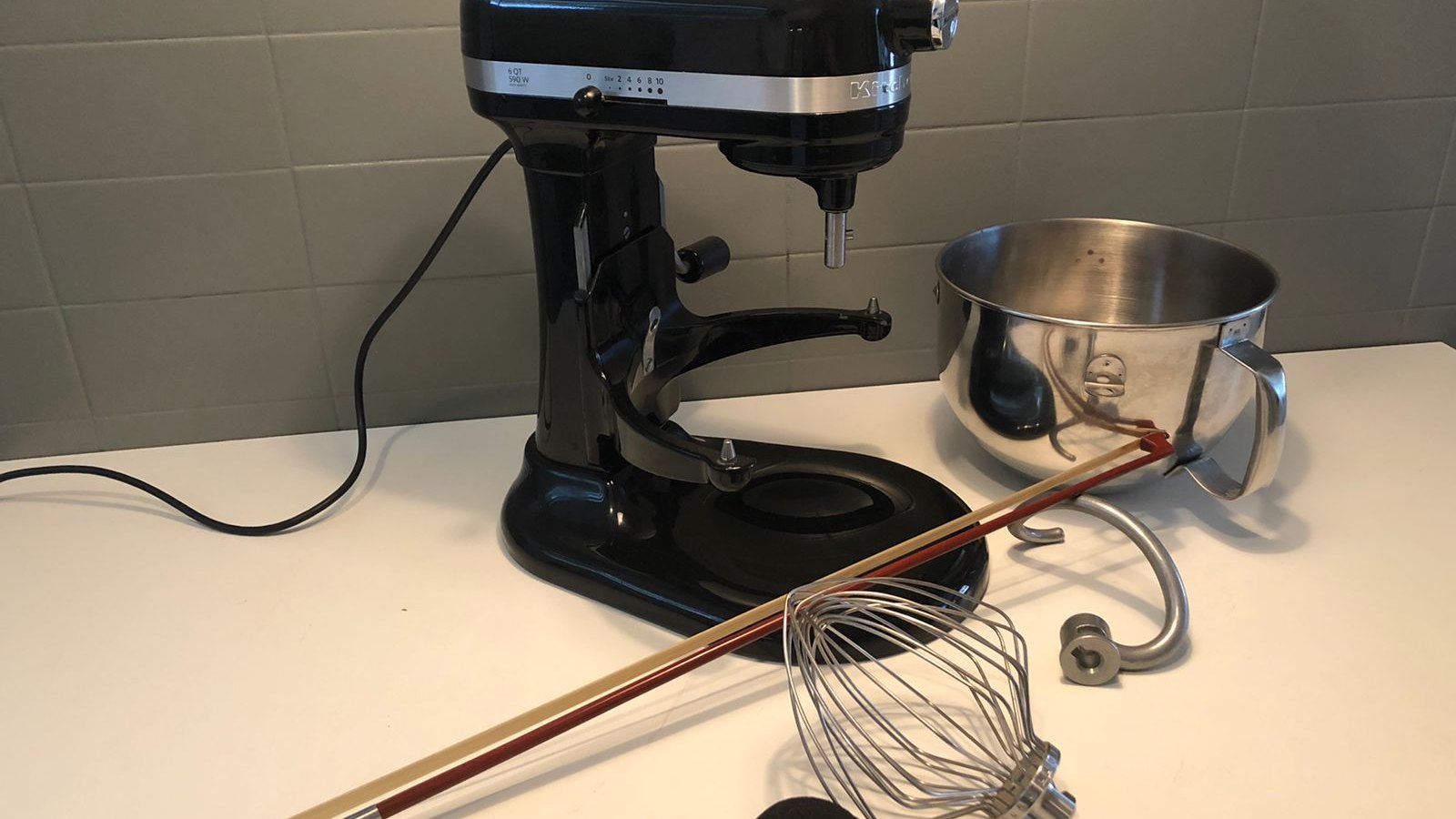 The recording set-up: a KitchenAid stand mixer, its bowl and whisk, a violin bow and a handheld recorder