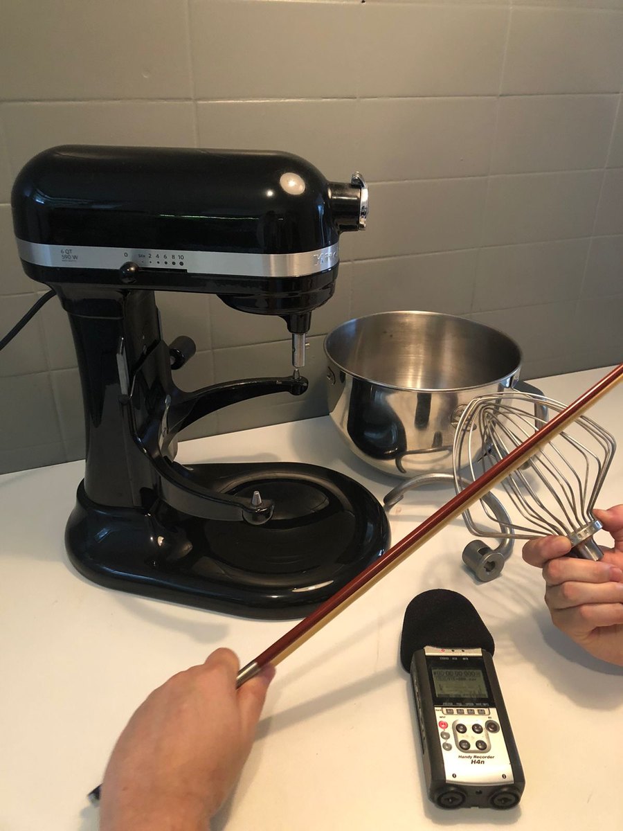A violin bow drawn across the wire whisk