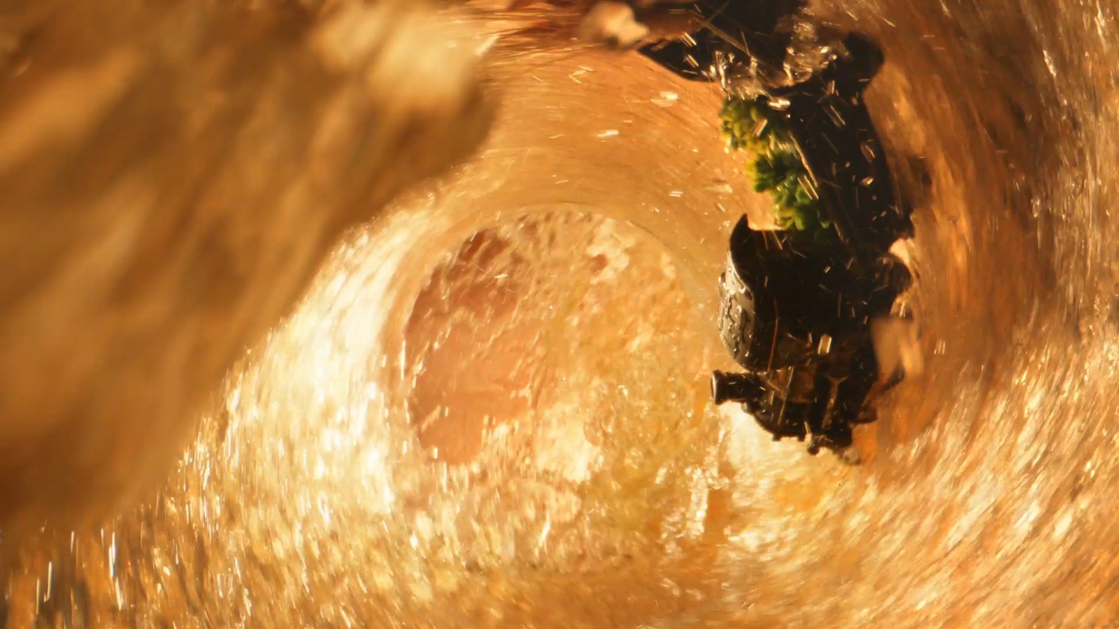 The train inside a swirling vortex of golden liquid