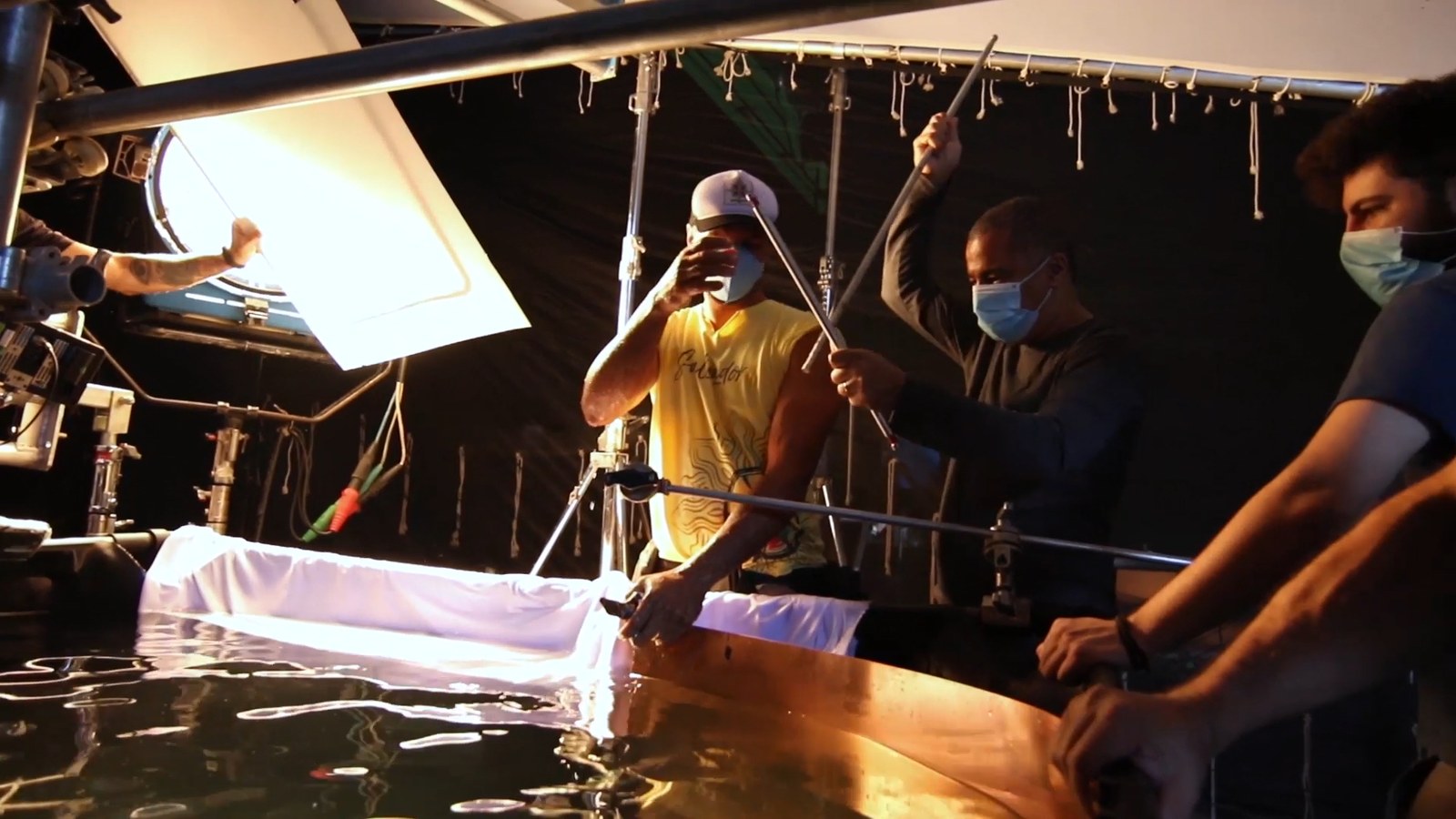 Crew holding lights and diffusion over a copper tank