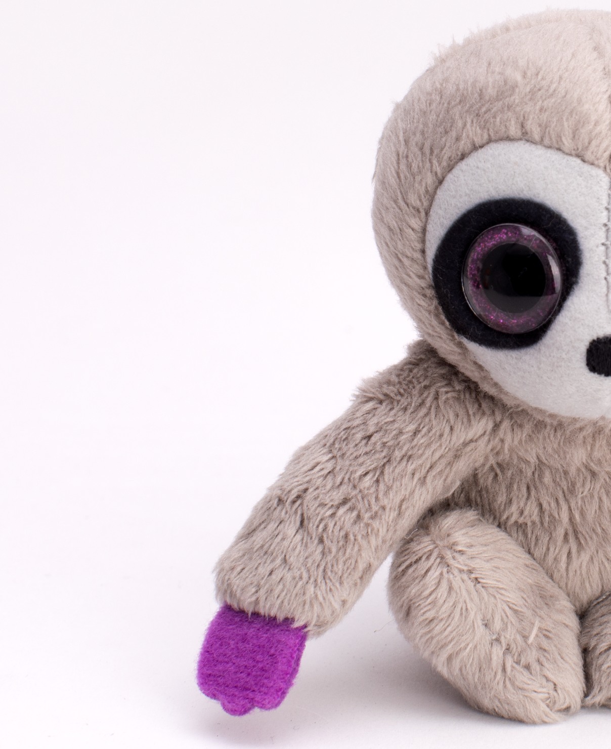 Macro of a plush sloth toy showing fur and felt