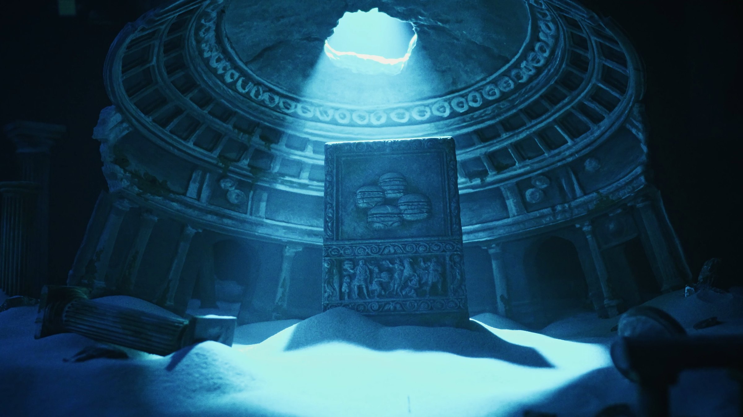 A sunken rotunda, a shaft of light through its broken dome, a carved stone tablet standing in the sand