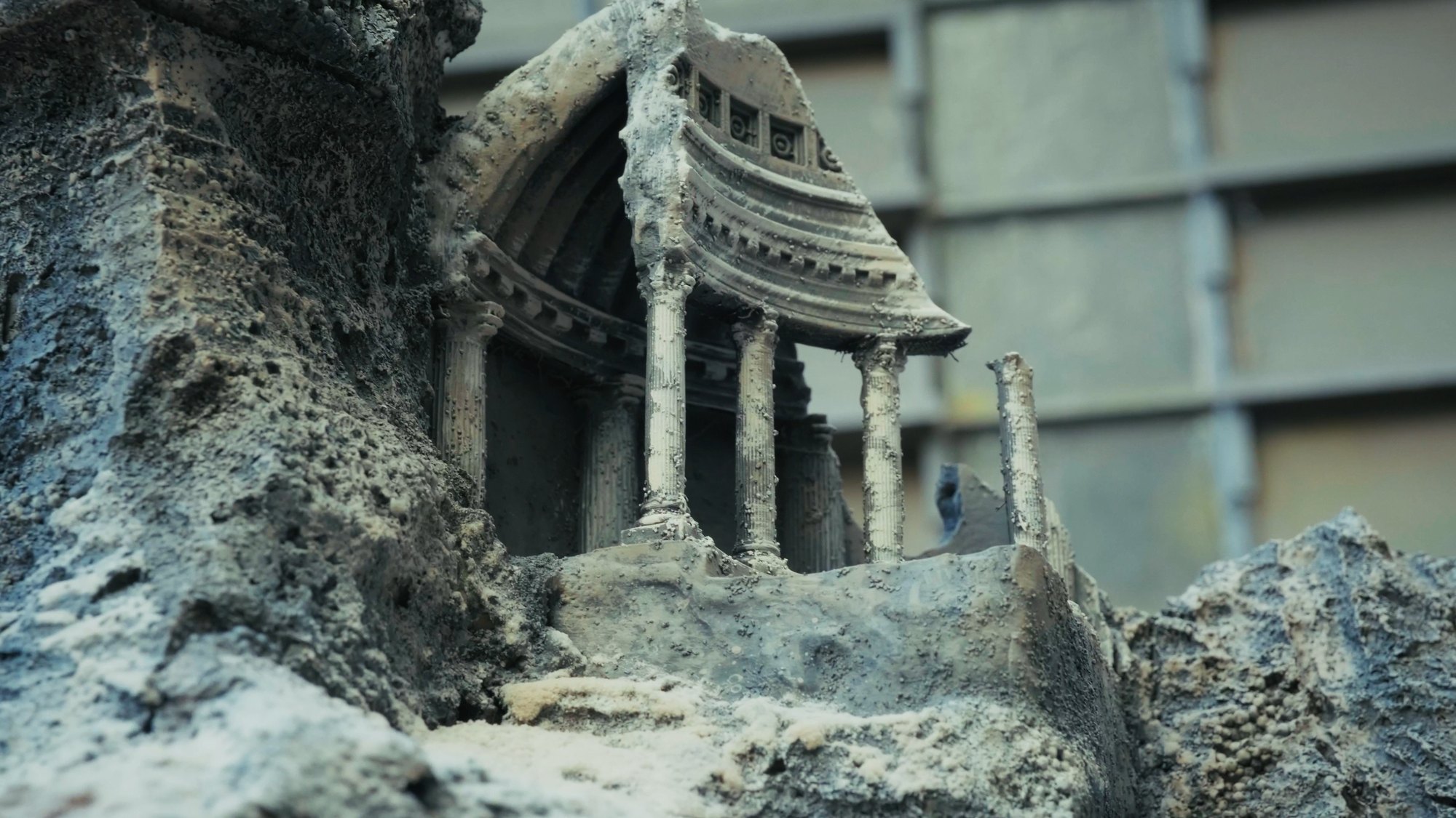 Close on the sculpted temple, salt-crusted columns and a broken pediment