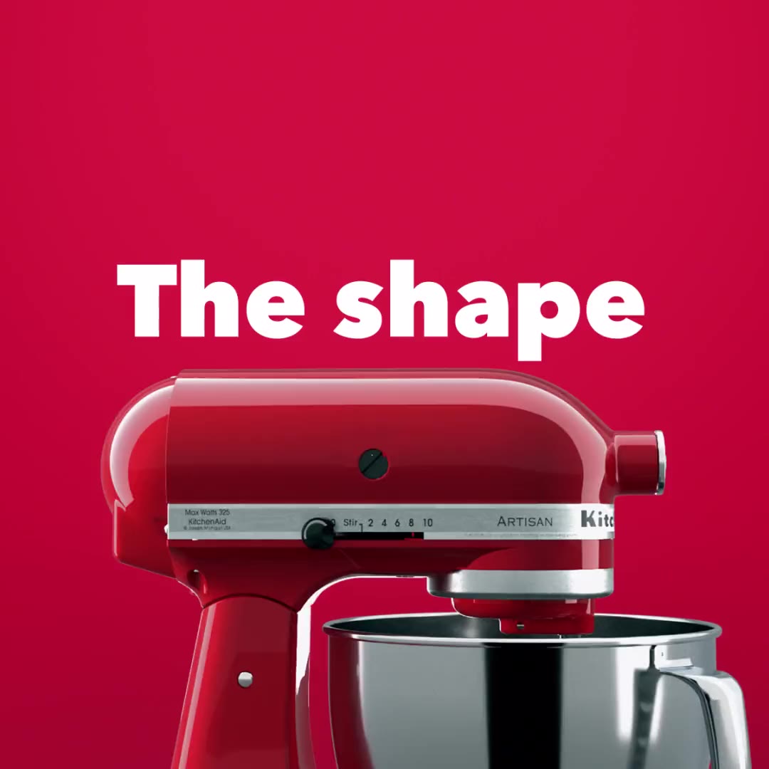 A crimson KitchenAid Artisan mixer turning against a matching red field
