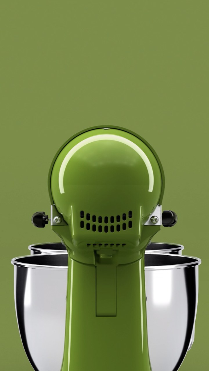 A green KitchenAid mixer with the word penne breaking apart in white type