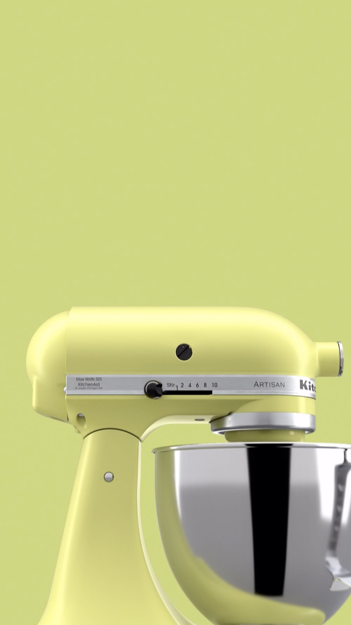 A mint green KitchenAid mixer shot close, the word protrude in white type