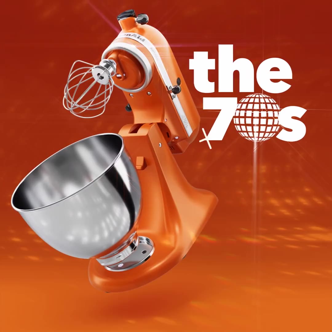 An orange KitchenAid Artisan mixer with the words the 70s in white