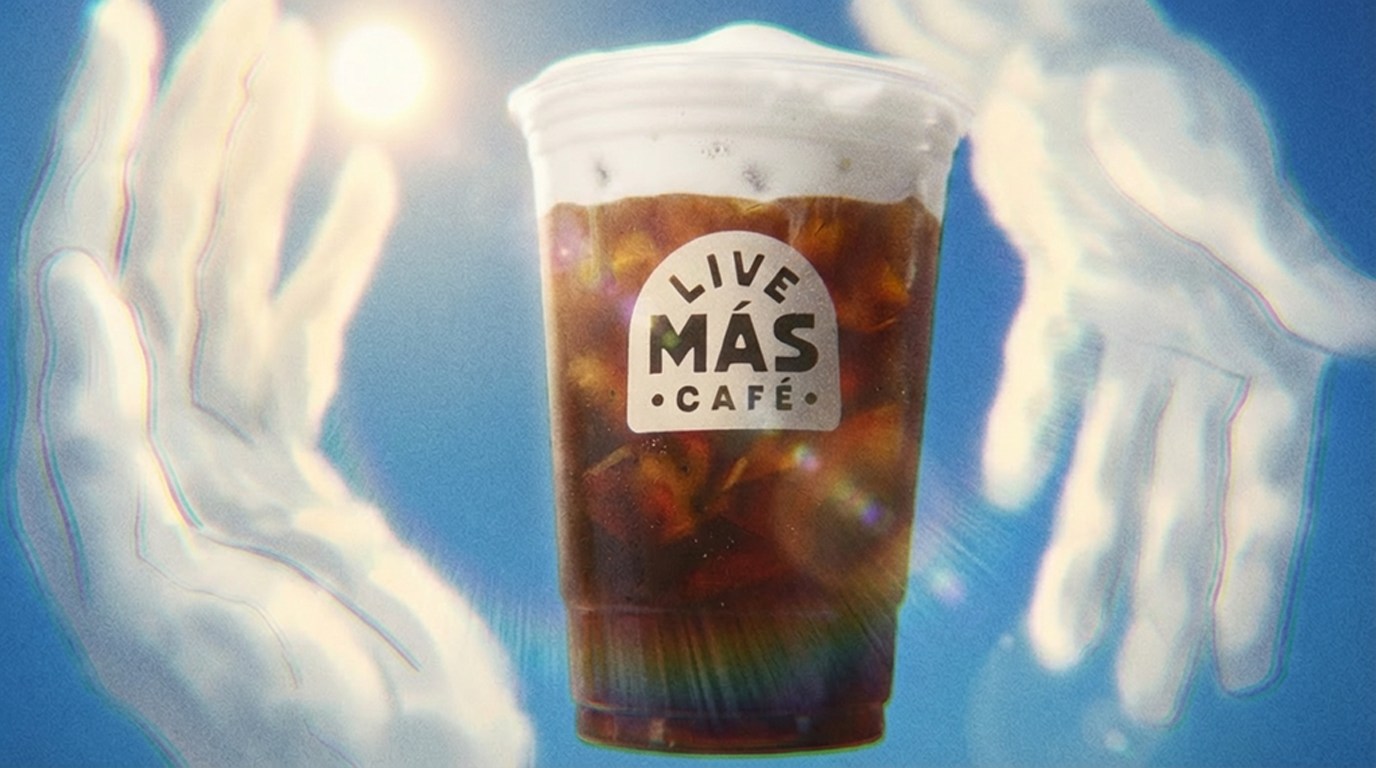 Concept frame of gloved hands presenting a cold brew cup in the clouds